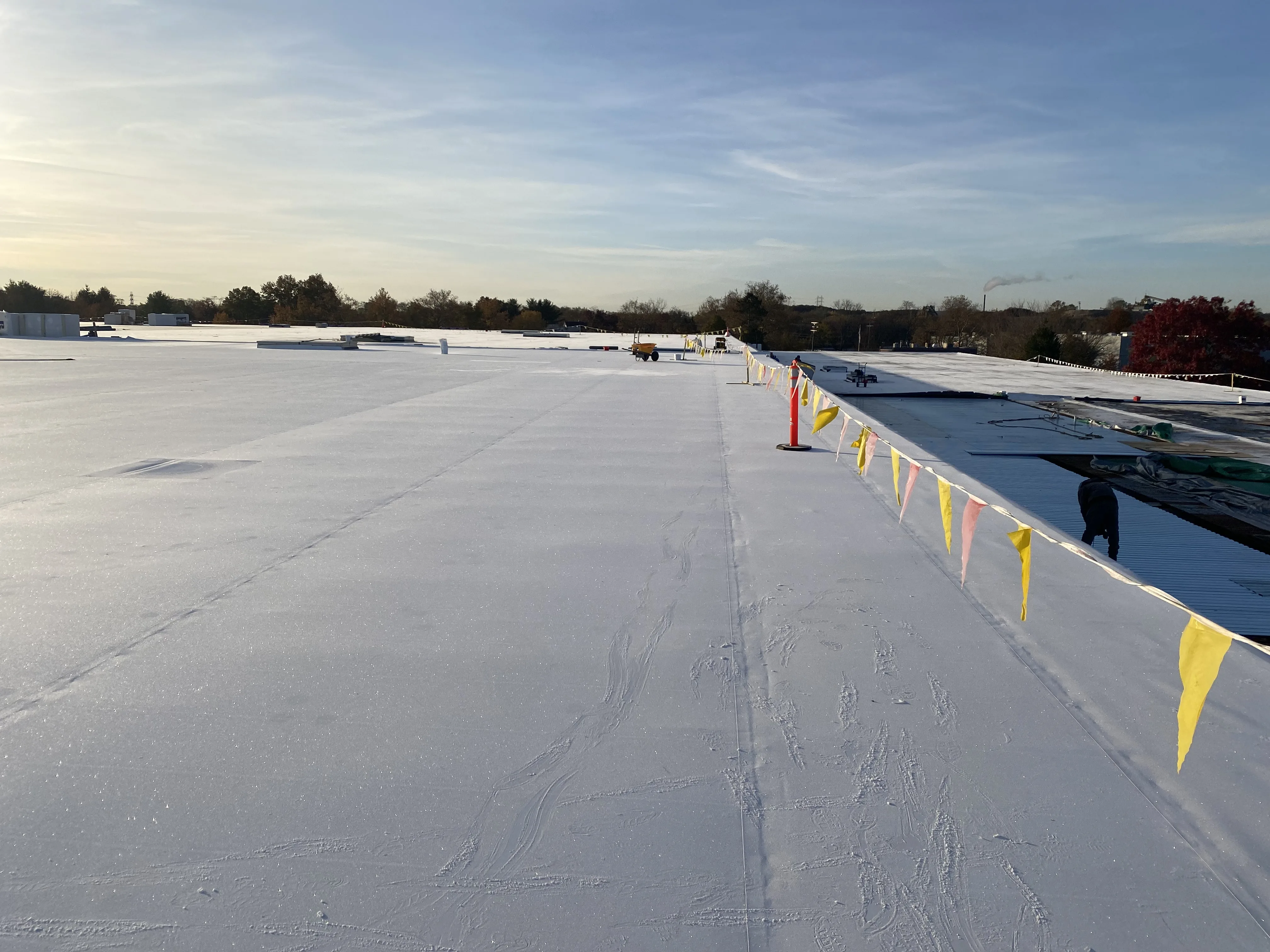 Completed TPO roofing system at sunrise