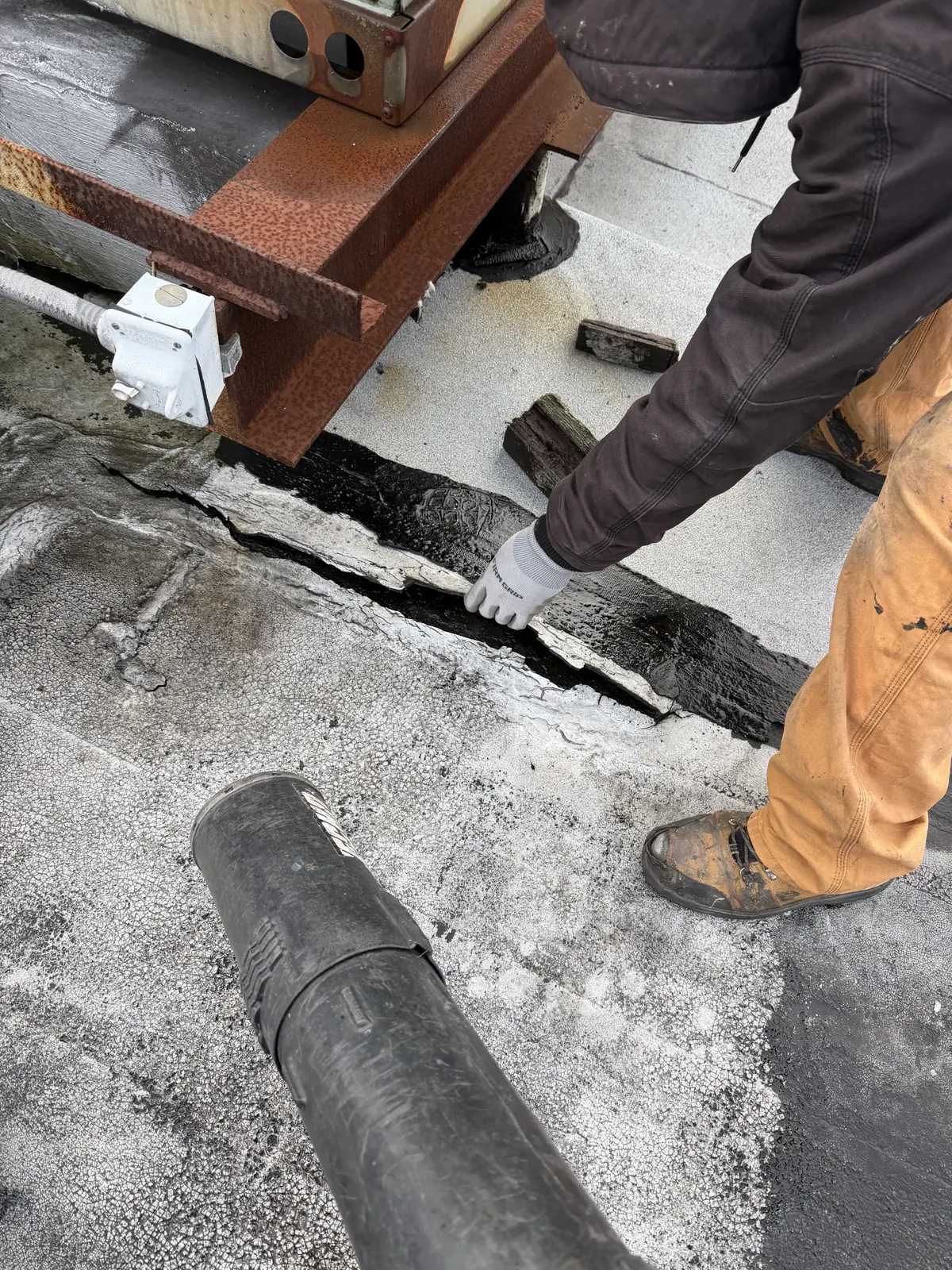 Close-up of a commercial roof seam being repaired by CCM Roofing crew