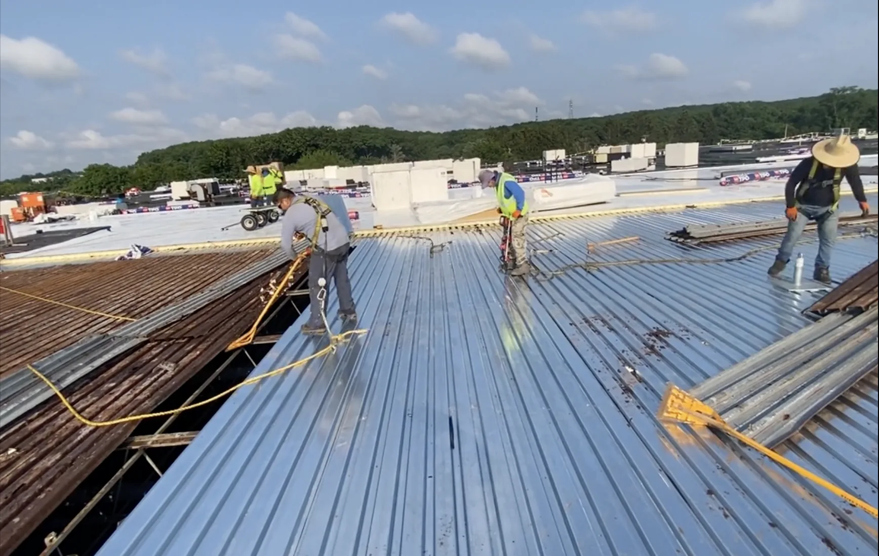 Steel deck replacement showing new galvanized panels installed over old deck