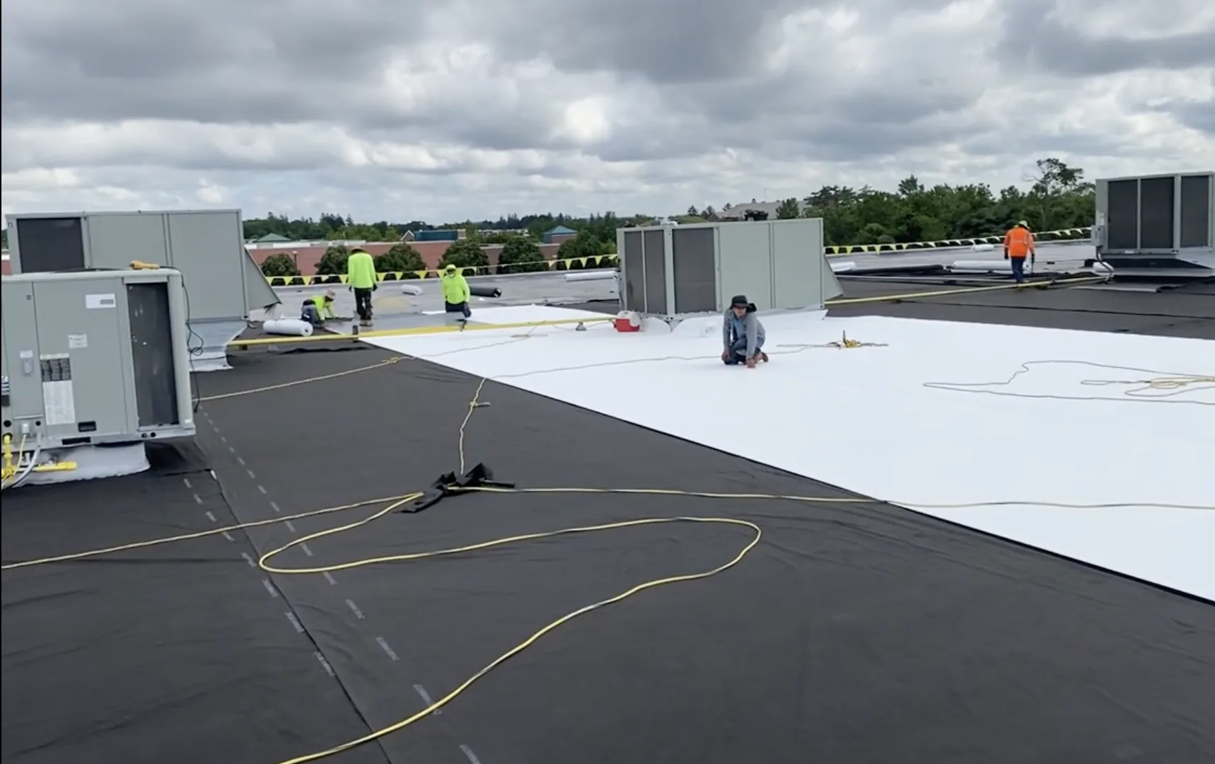 CCM Roofing crew installing new TPO roof membrane