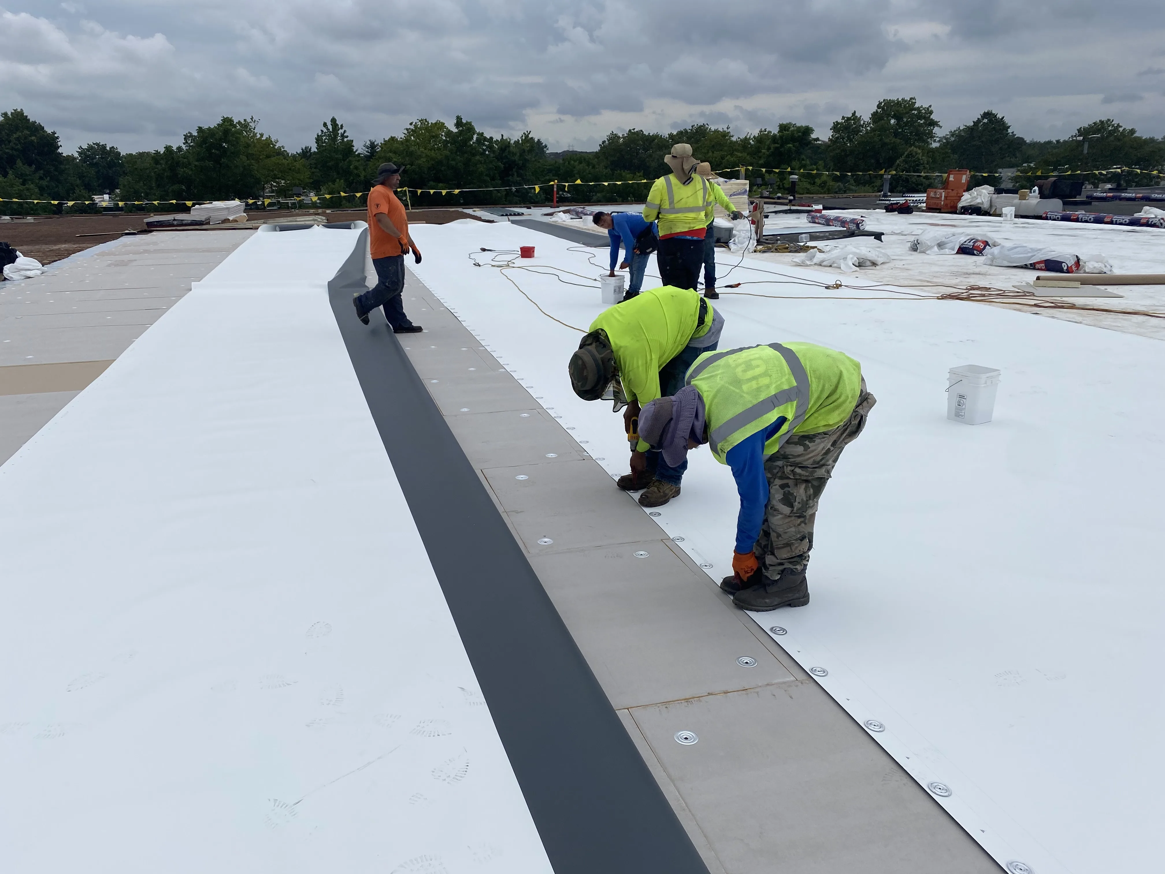 CCM Roofing crew installing a new commercial TPO roof
